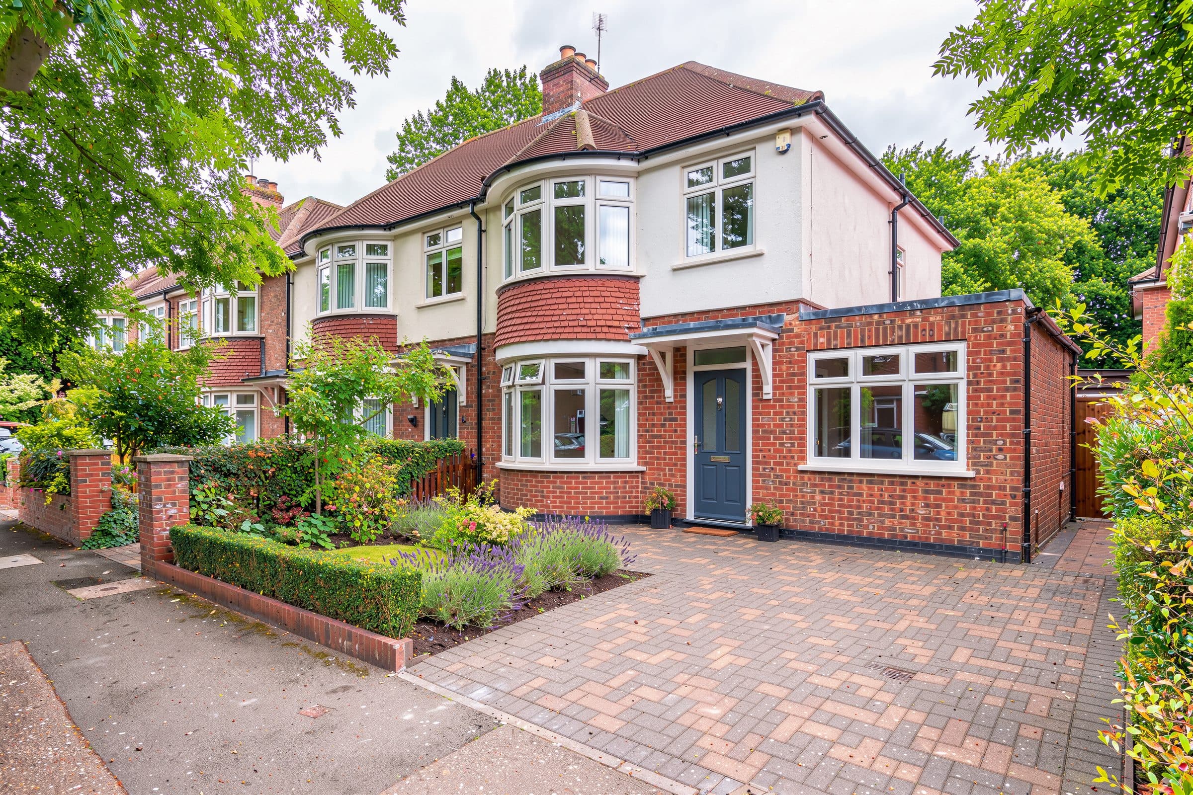 Bay-fronted 1930s semi with block-paved drive