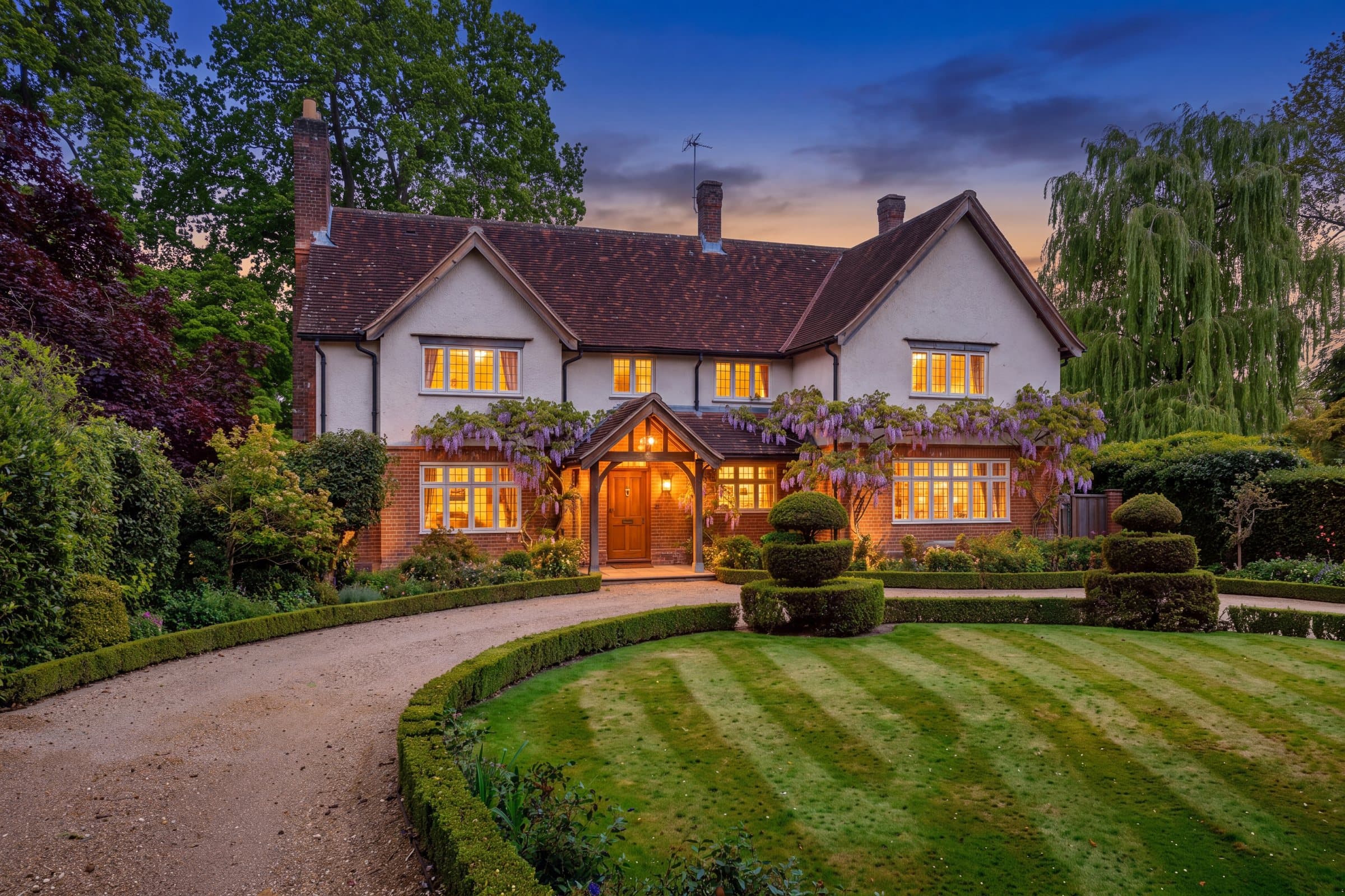 Wisteria House at dusk, lit from within